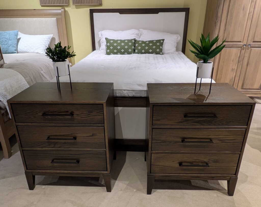 Why Visit Amish Oak & Cherry at the Hickory Furniture Mart 1 Amish bedroom set with dark wood nightstands, white upholstered bed, and wardrobe display.