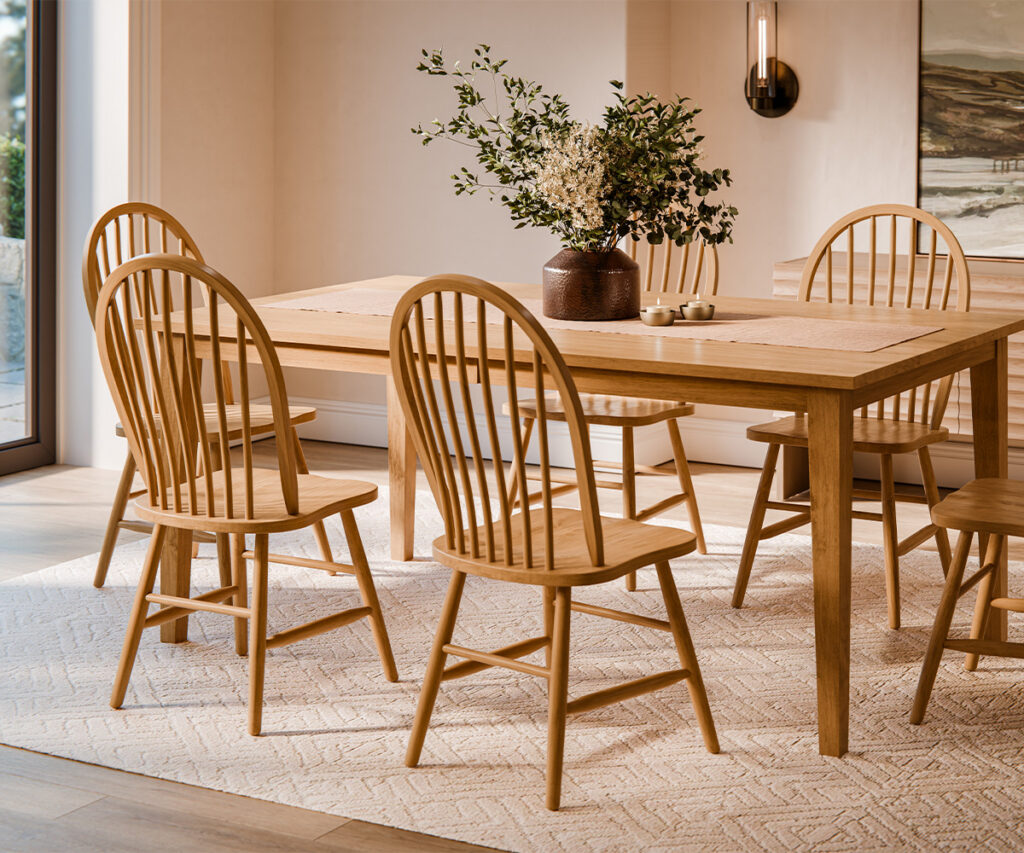 Why Visit Amish Oak & Cherry at the Hickory Furniture Mart 3 Light oak dining table with Windsor chairs in a sunlit dining room.